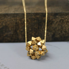 Close up of Gold Apollo Pendant