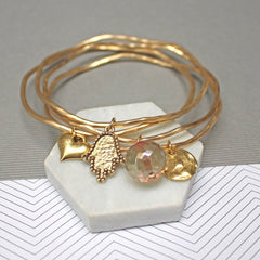 Close up of Gold Personalised Hamsa Stacking Bangles set