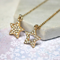 Close up of Diamante Star Thread Through Earrings gold
