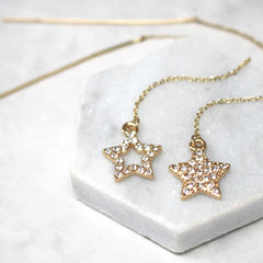 Close up of Diamante Star Thread Through Earrings gold