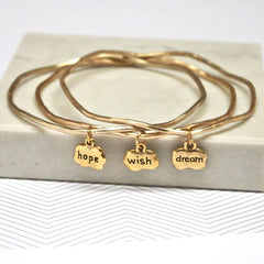Close up of gold Hope Wish Dream Mantra Bangles set