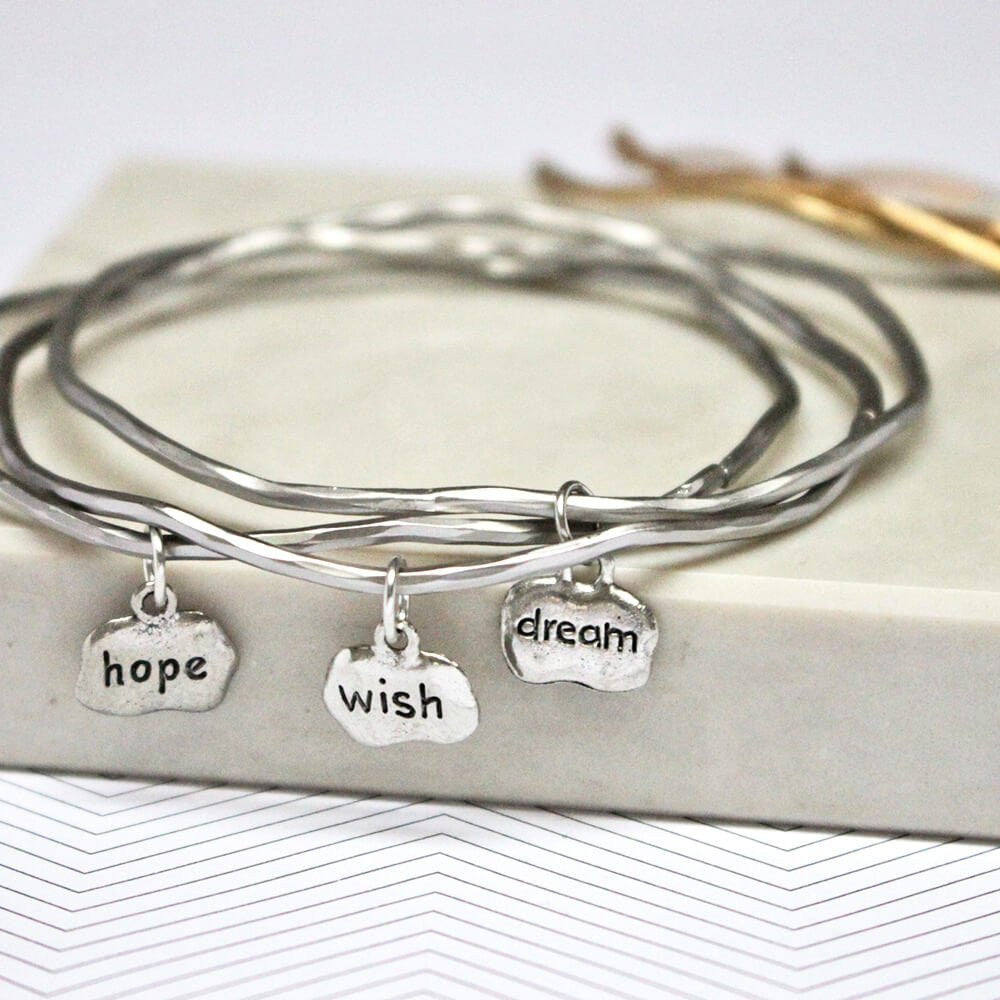 Close up of silver Hope Wish Dream Mantra Bangles set