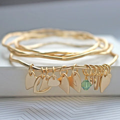 Matt gold bangle set with personalised heart charms and mint green Swarovski crystal