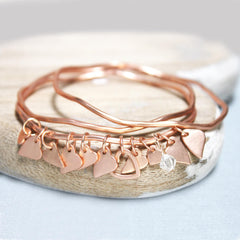 Matt rose gold bangles set with personalised heart and clear Swarovski crystal