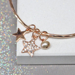 Close up of rose gold bracelet with diamante star and pearl. Can be personalised for gift for her.