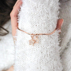 Stunning rose gold bangle worn on model's wrist