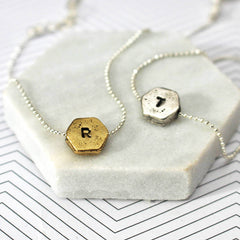 Hand stamped initial bracelets in gold and silver