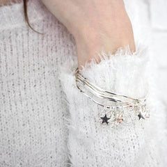 Model wearing silver diamante star bangle set