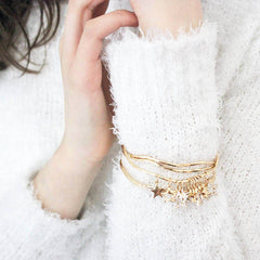 Model wearing gold diamante star bangle set