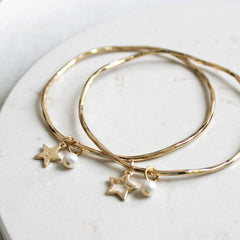 24ct gold plated bangle with open or solid star charm and a freshwater pearl