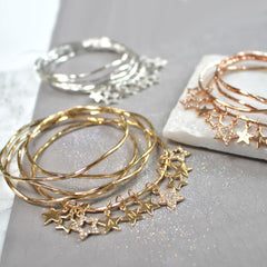 Gold, silver and rose gold bangles set with diamante star bangles