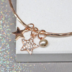 Close up of rose gold bracelet with diamante star and pearl. Can be personalised for gift for her. 