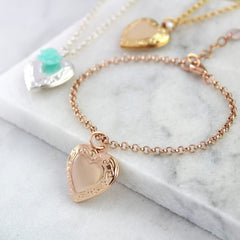 Rose gold vintage heart locket with gold and silver in the background
