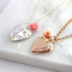 Rose gold and silver vintage heart locket necklaces sitting side by side with hidden message