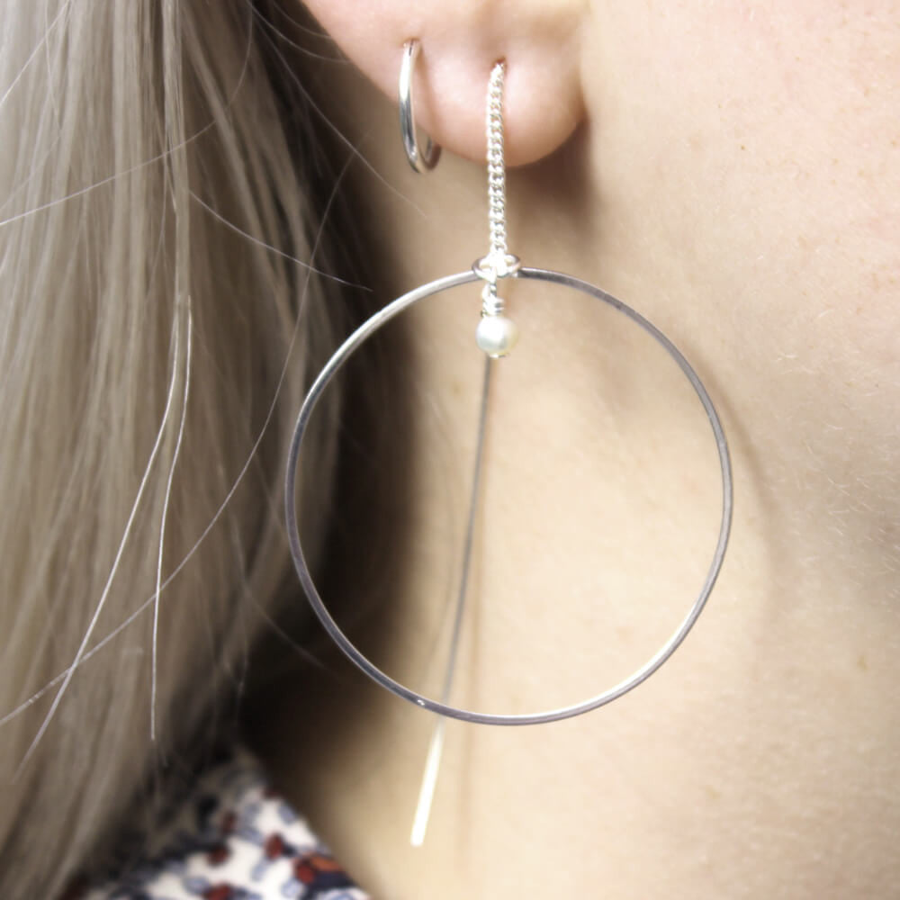 Close up of Thread Through Hoop Earrings silver