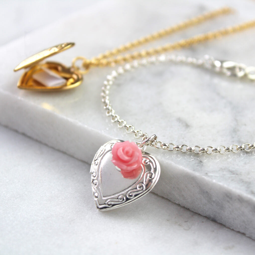 Silver vintage heart locket bracelet with rosey pink rose with gold message locket in the background