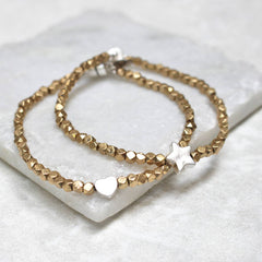 Close up of Gold Bead Charm Bracelets
