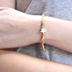 Close up of Gold Bead Charm Bracelet with star charm