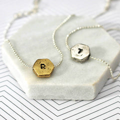 Hand stamped hexagon necklace with R and T in silver and gold